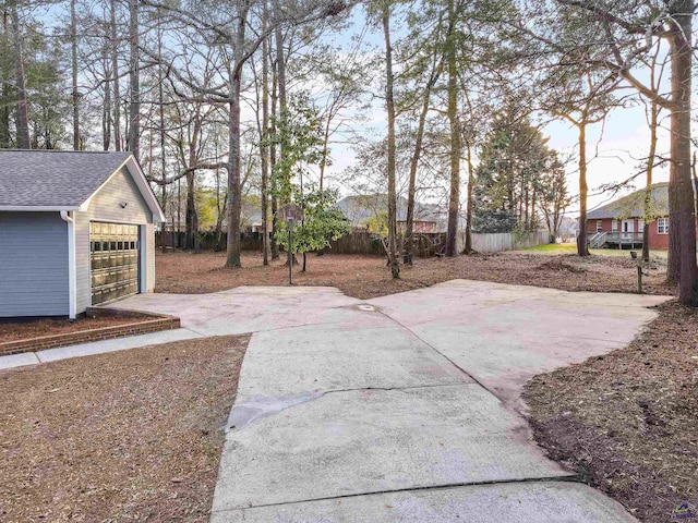view of yard with a garage, an outdoor structure, and fence