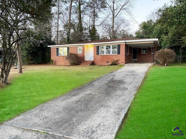 ranch-style home with a carport, crawl space, driveway, and a front lawn