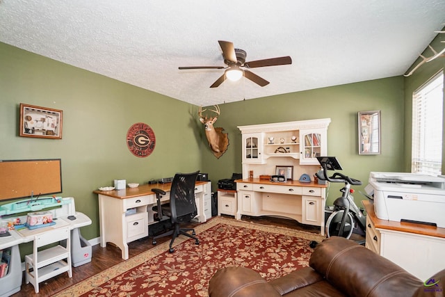 home office featuring baseboards, a textured ceiling, a ceiling fan, and wood finished floors