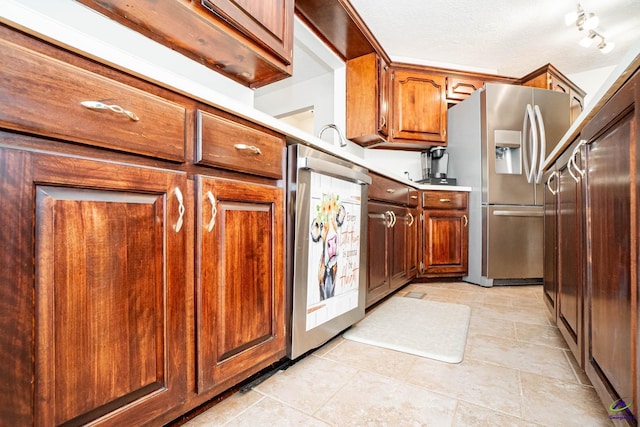 kitchen featuring brown cabinets, stainless steel appliances, and light countertops