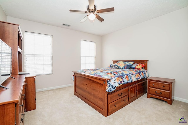 bedroom with light carpet, multiple windows, visible vents, and baseboards