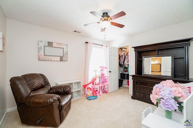 bedroom featuring a spacious closet, a closet, visible vents, and light colored carpet