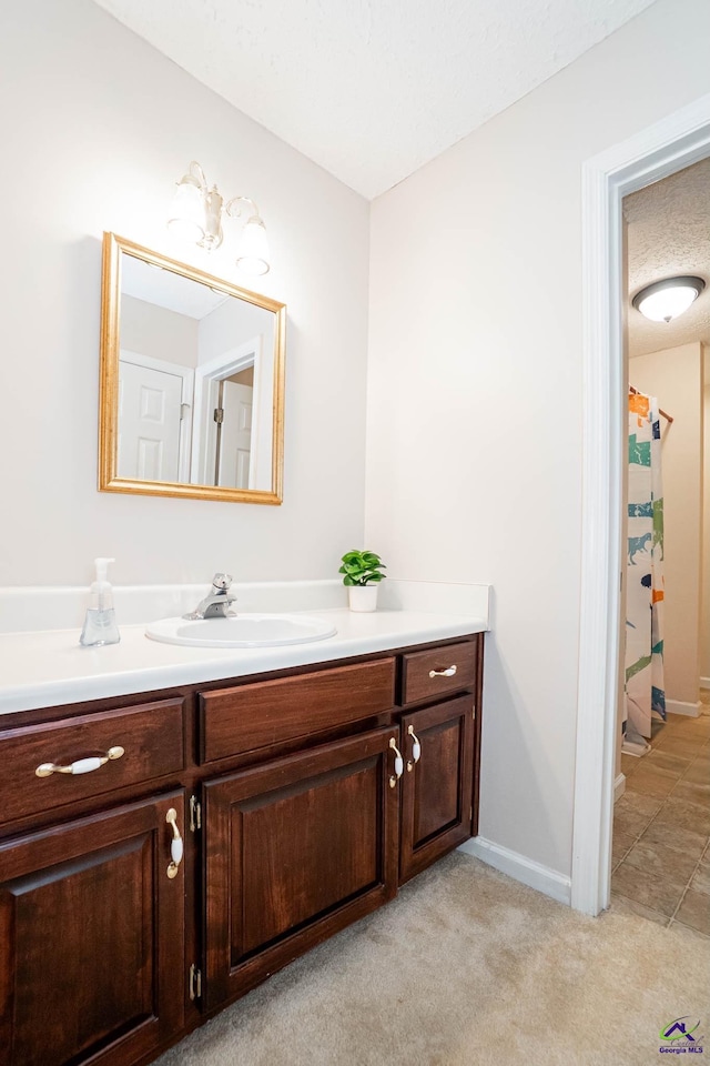 bathroom featuring a shower with shower curtain, vanity, and baseboards