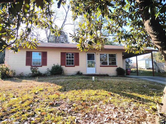 ranch-style home with an attached carport and concrete block siding