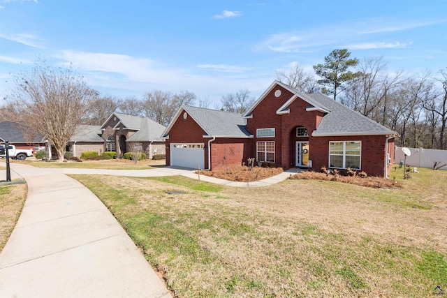 view of front of property with brick siding, roof with shingles, a front yard, and fence