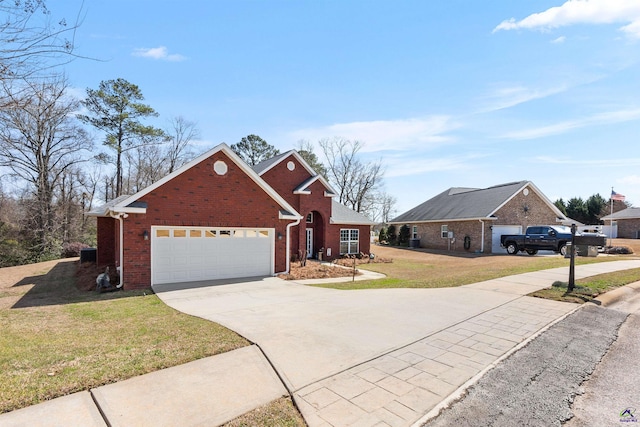 traditional home with brick siding, driveway, an attached garage, and a front yard