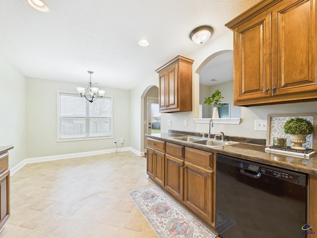 kitchen with a sink, dark countertops, brown cabinetry, baseboards, and dishwasher