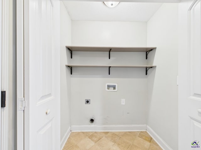 laundry room with hookup for a washing machine, hookup for an electric dryer, and baseboards