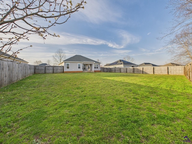 view of yard with a fenced backyard