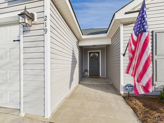 doorway to property with an attached garage