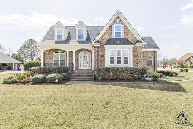 view of front of property featuring brick siding, roof with shingles, and a front lawn