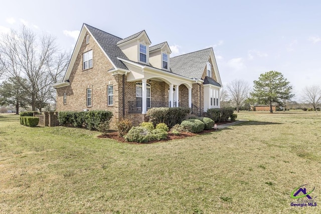 view of home's exterior featuring a yard and brick siding