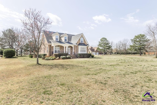 view of front facade with brick siding and a front lawn