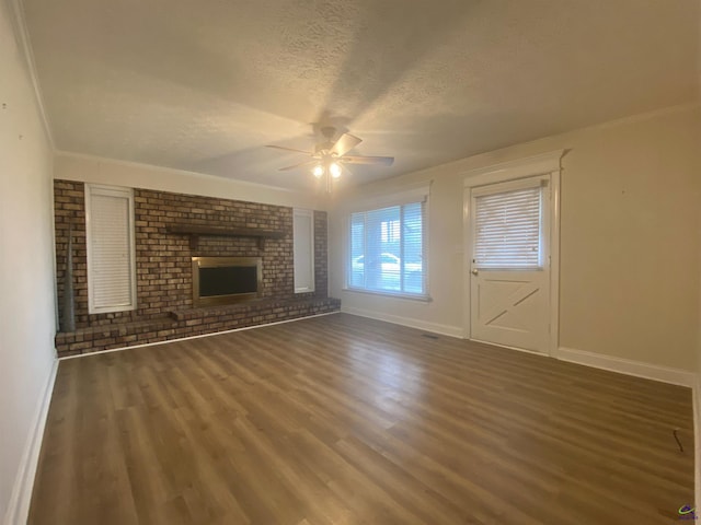 unfurnished living room with baseboards, ceiling fan, a fireplace, wood finished floors, and a textured ceiling