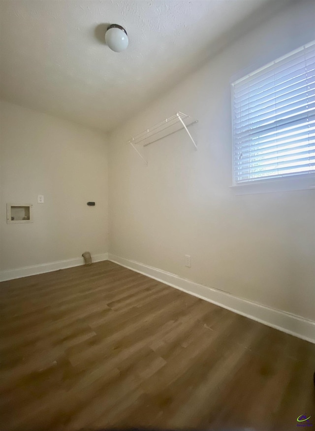 washroom featuring baseboards, dark wood-type flooring, hookup for a washing machine, and laundry area