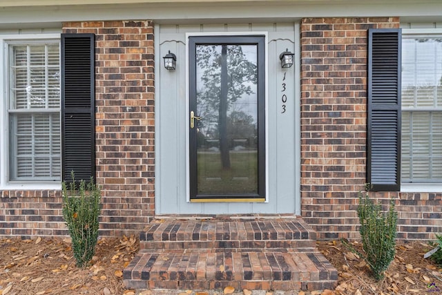 property entrance with brick siding