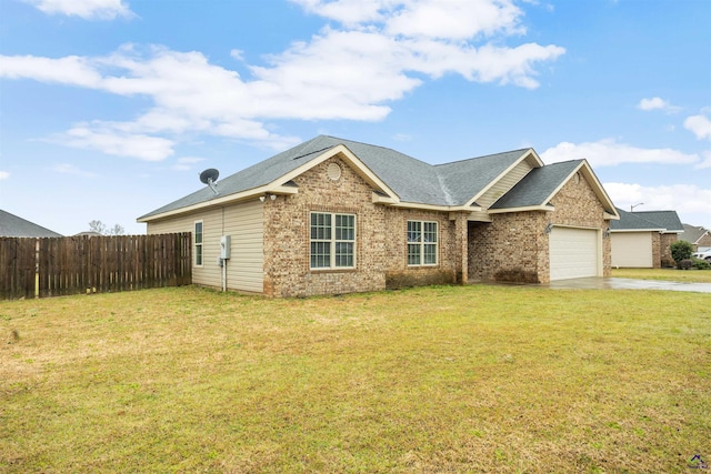 single story home with a front yard, fence, driveway, an attached garage, and brick siding