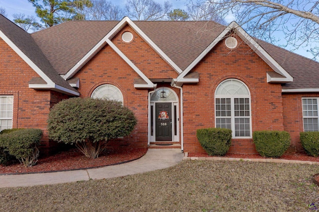 traditional-style home with brick siding and a shingled roof