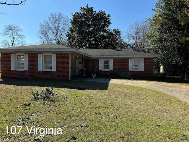 ranch-style home with brick siding, concrete driveway, and a front lawn