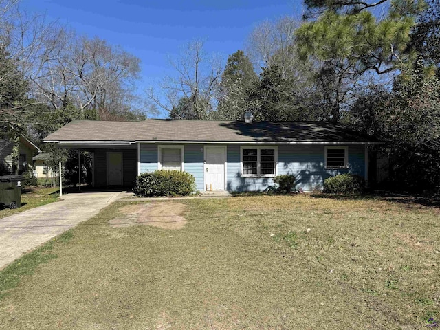 single story home featuring driveway, an attached carport, and a front yard