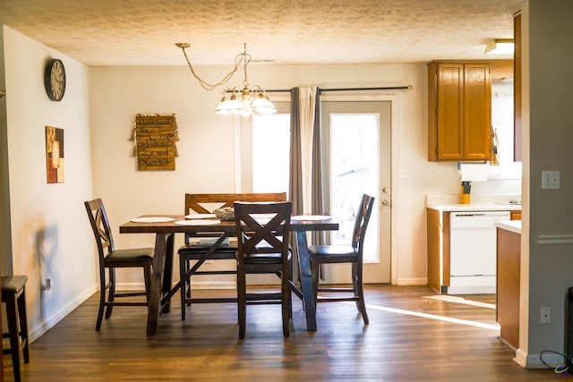 dining space with baseboards, a notable chandelier, dark wood-style floors, and a textured ceiling