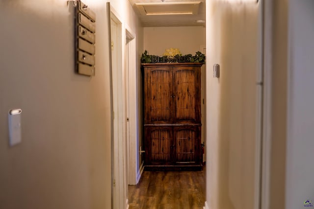 hallway featuring attic access and dark wood finished floors