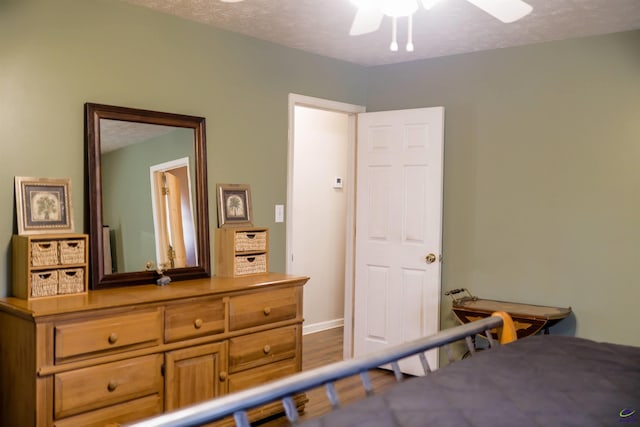 bedroom featuring a textured ceiling and wood finished floors