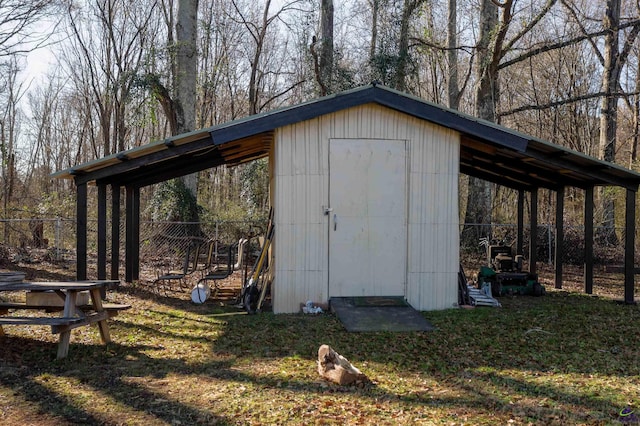 view of shed featuring a detached carport and fence