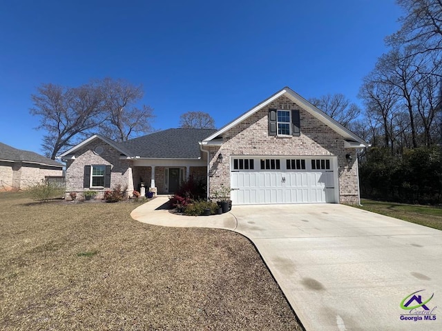 view of front of home with brick siding, driveway, and a garage