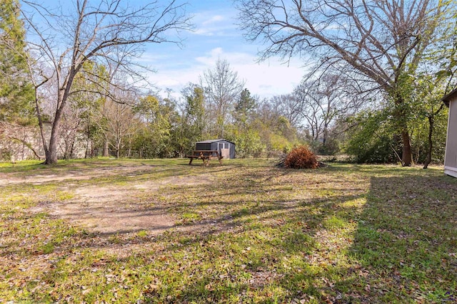 view of yard featuring an outbuilding and a shed