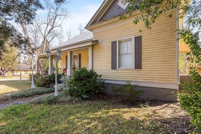 view of side of home with covered porch