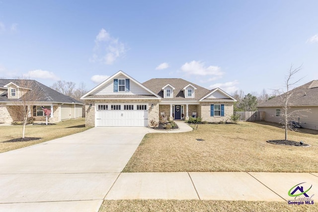 view of front facade with brick siding, concrete driveway, a front yard, and fence