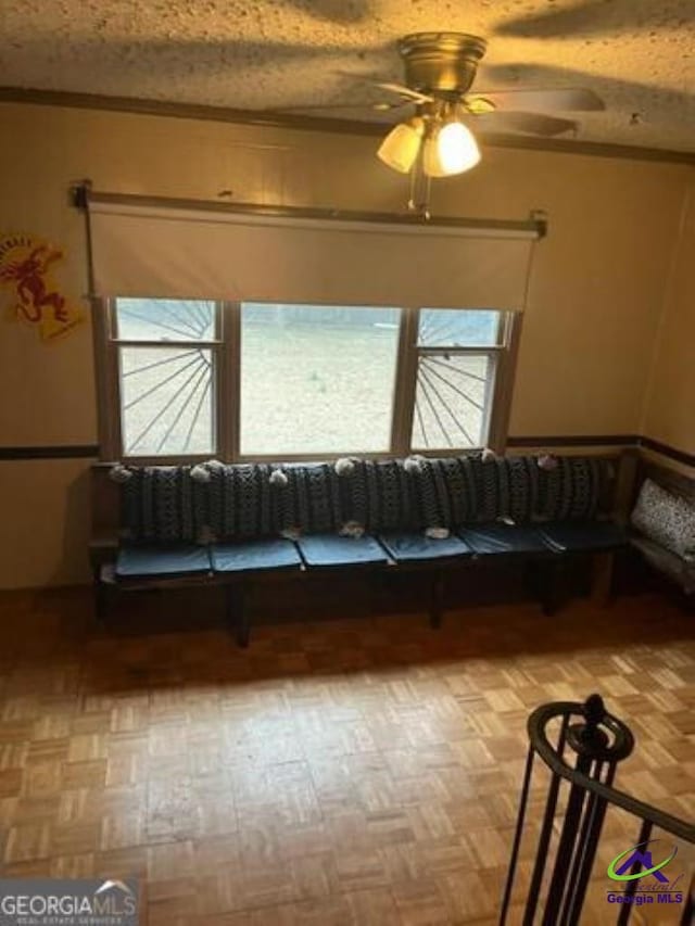 unfurnished living room with parquet flooring, a textured ceiling, and a ceiling fan