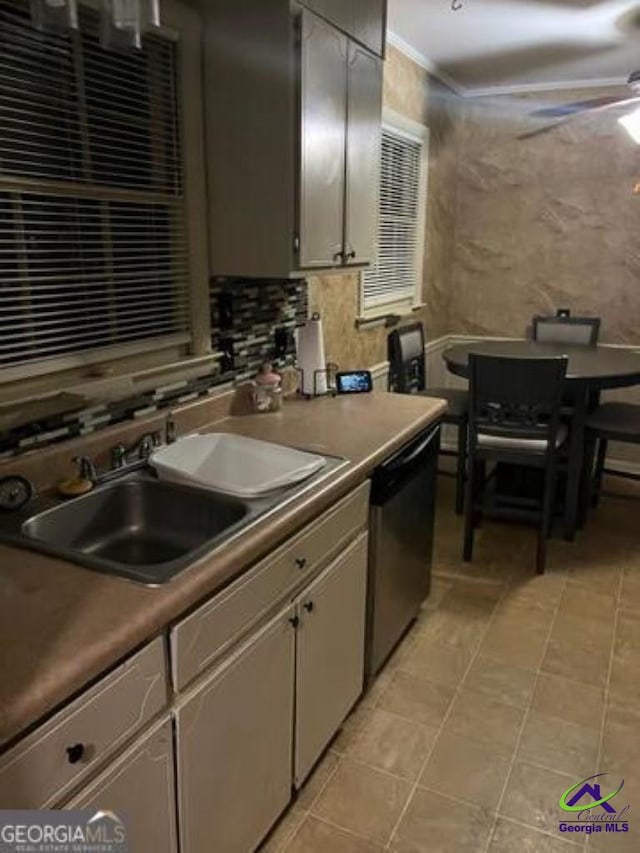 kitchen featuring light tile patterned floors, ceiling fan, decorative backsplash, a sink, and stainless steel dishwasher