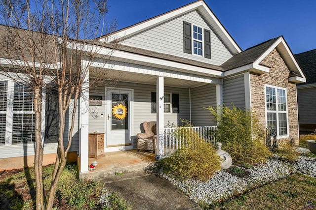 view of front of home featuring stone siding and a porch