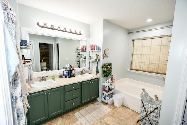 full bathroom with a sink, toilet, a bath, and double vanity