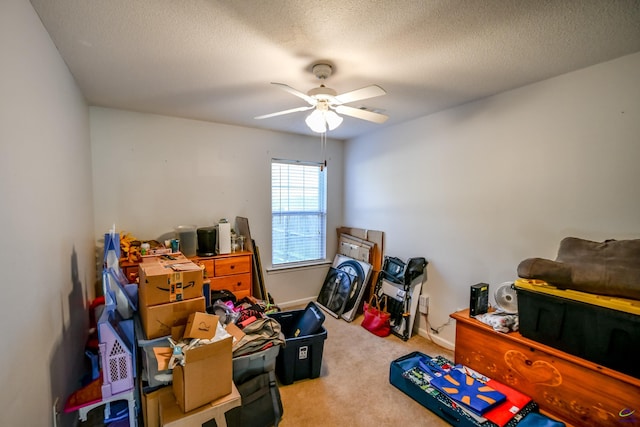 interior space with baseboards, carpet flooring, a textured ceiling, and ceiling fan