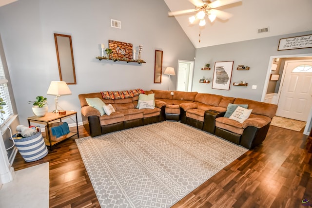 living room with visible vents, dark wood-type flooring, high vaulted ceiling, and a ceiling fan