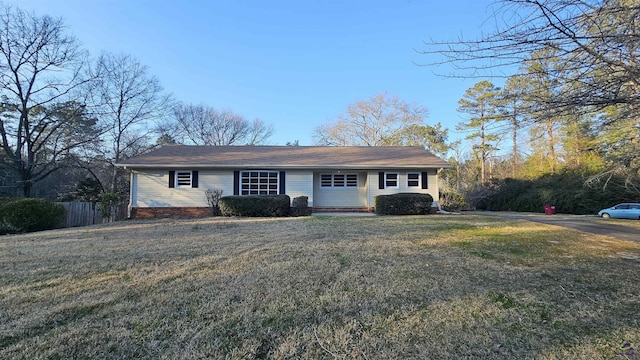 single story home featuring a front yard and fence