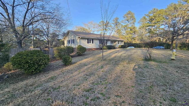 ranch-style house with fence