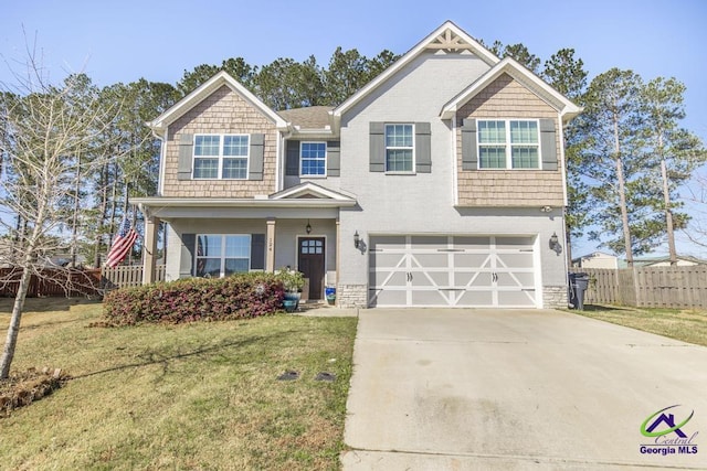 craftsman-style home with a front lawn, fence, concrete driveway, an attached garage, and brick siding