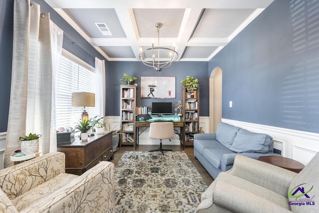 office space featuring arched walkways, visible vents, a notable chandelier, and a wainscoted wall