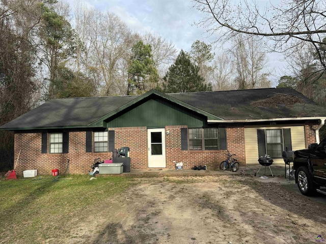 single story home featuring a front lawn and brick siding