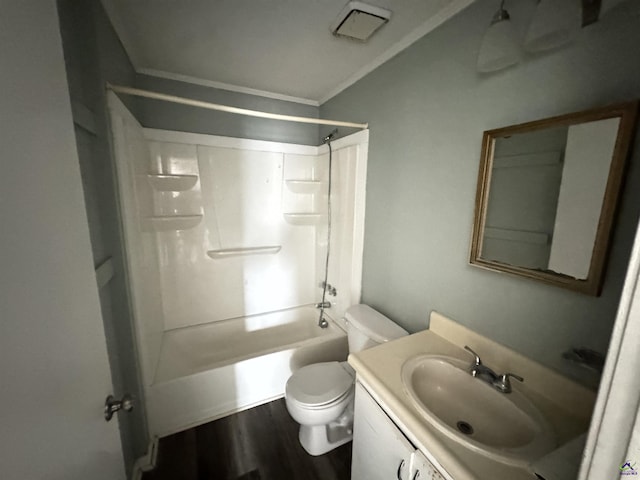 bathroom with crown molding, shower / washtub combination, toilet, wood finished floors, and vanity