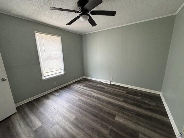 unfurnished room with visible vents, baseboards, dark wood finished floors, and ornamental molding