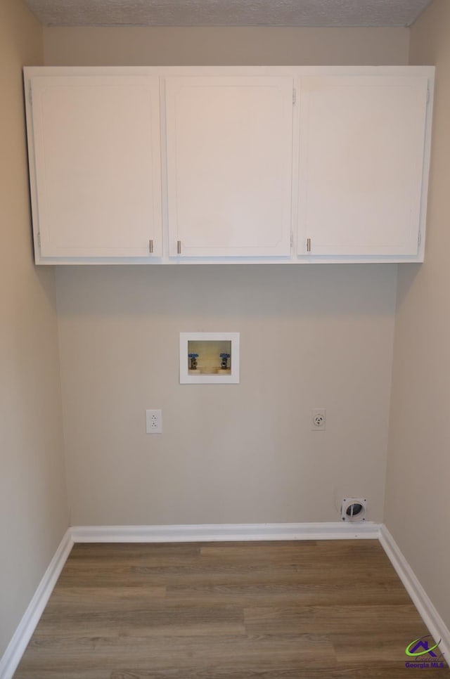 laundry room featuring hookup for a washing machine, wood finished floors, baseboards, and hookup for an electric dryer