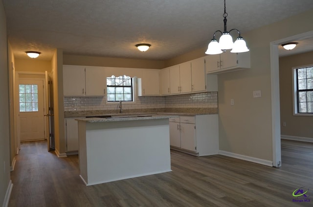 kitchen featuring light countertops, white cabinets, plenty of natural light, and dark wood-style floors