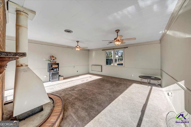 carpeted living area featuring ceiling fan, visible vents, and ornamental molding