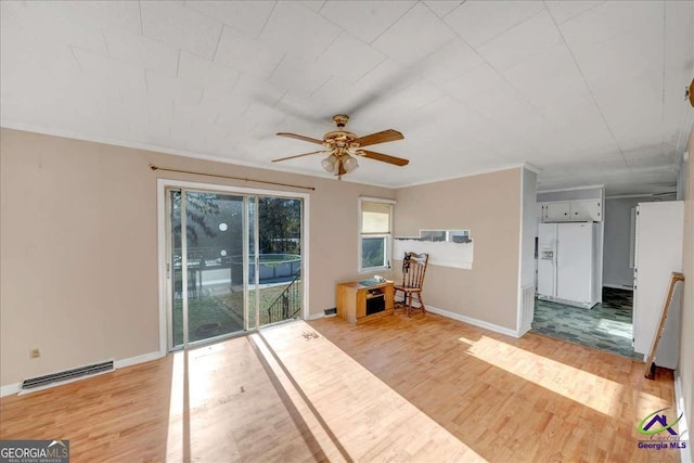 unfurnished room featuring light wood-style flooring, baseboards, visible vents, and ornamental molding