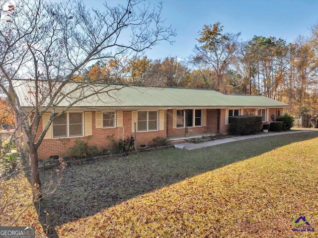 ranch-style house featuring brick siding and a front lawn